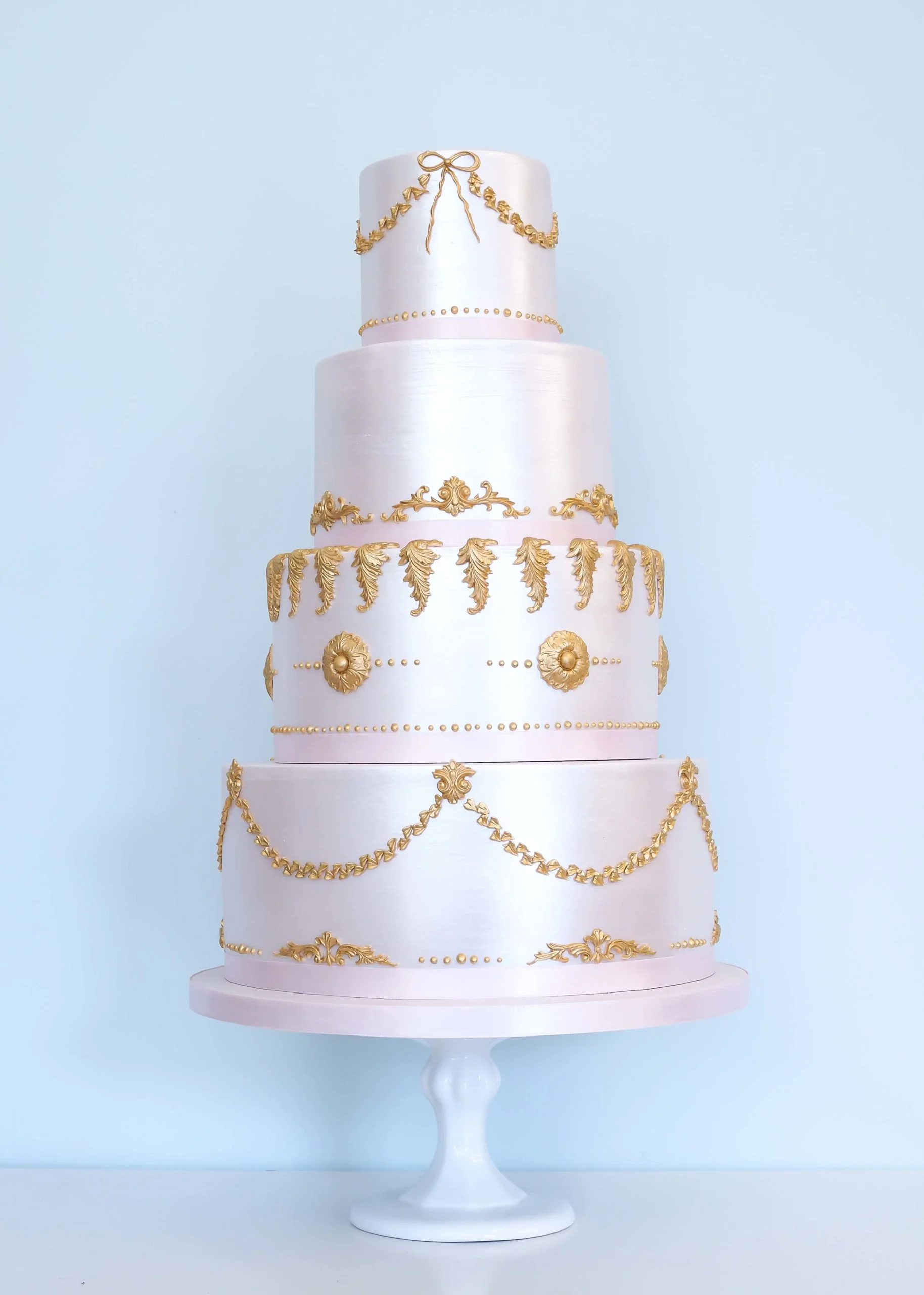 Pink and gold baroque shimmer wedding cake